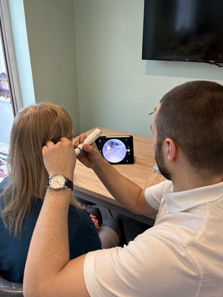 Specialist performing video otoscopy ear examination