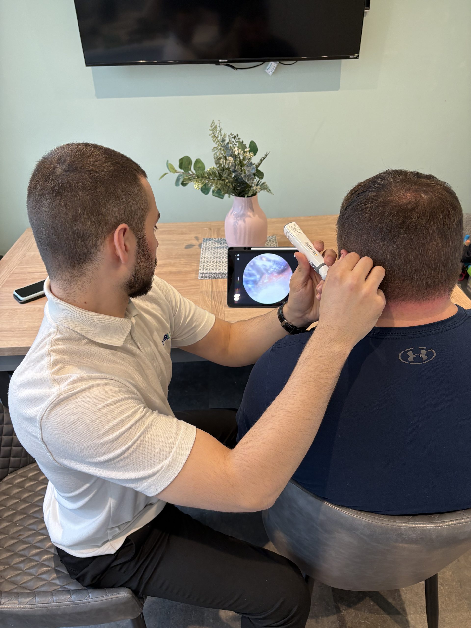 Earluxe practitioner using video otoscope during ear wax removal Newcastle upon Tyne home visit